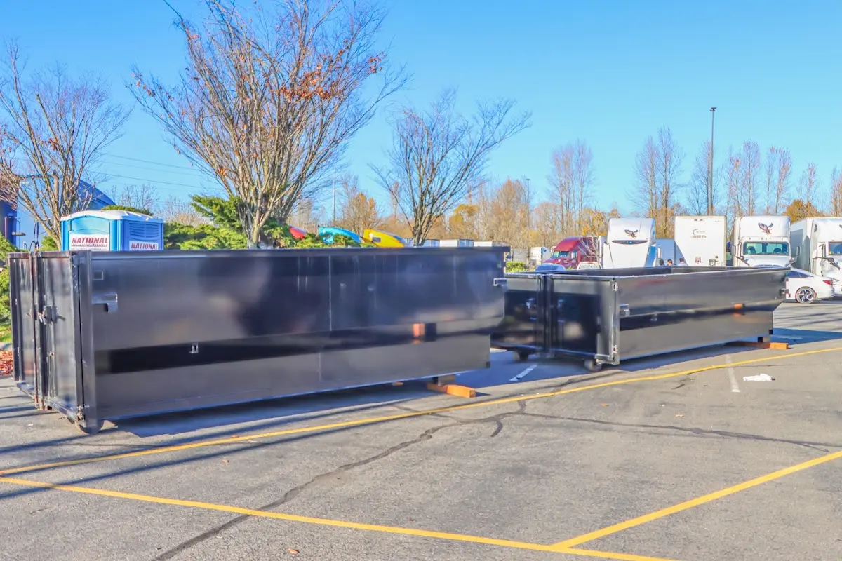 Professional dumpster rental service with roll-off container on residential driveway in Hope